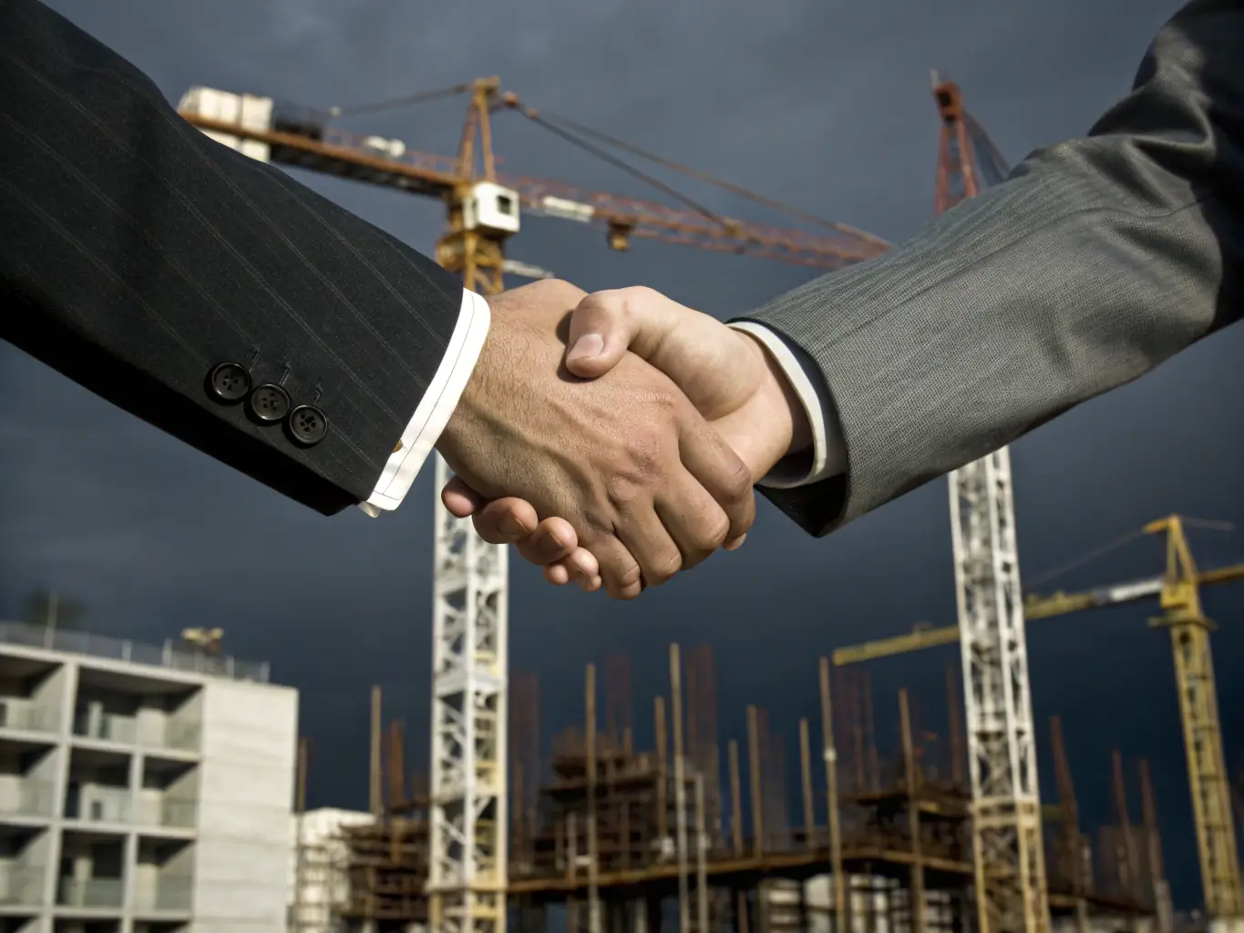 A handshake between a government official and a business executive, symbolizing a successful public-private partnership agreement.